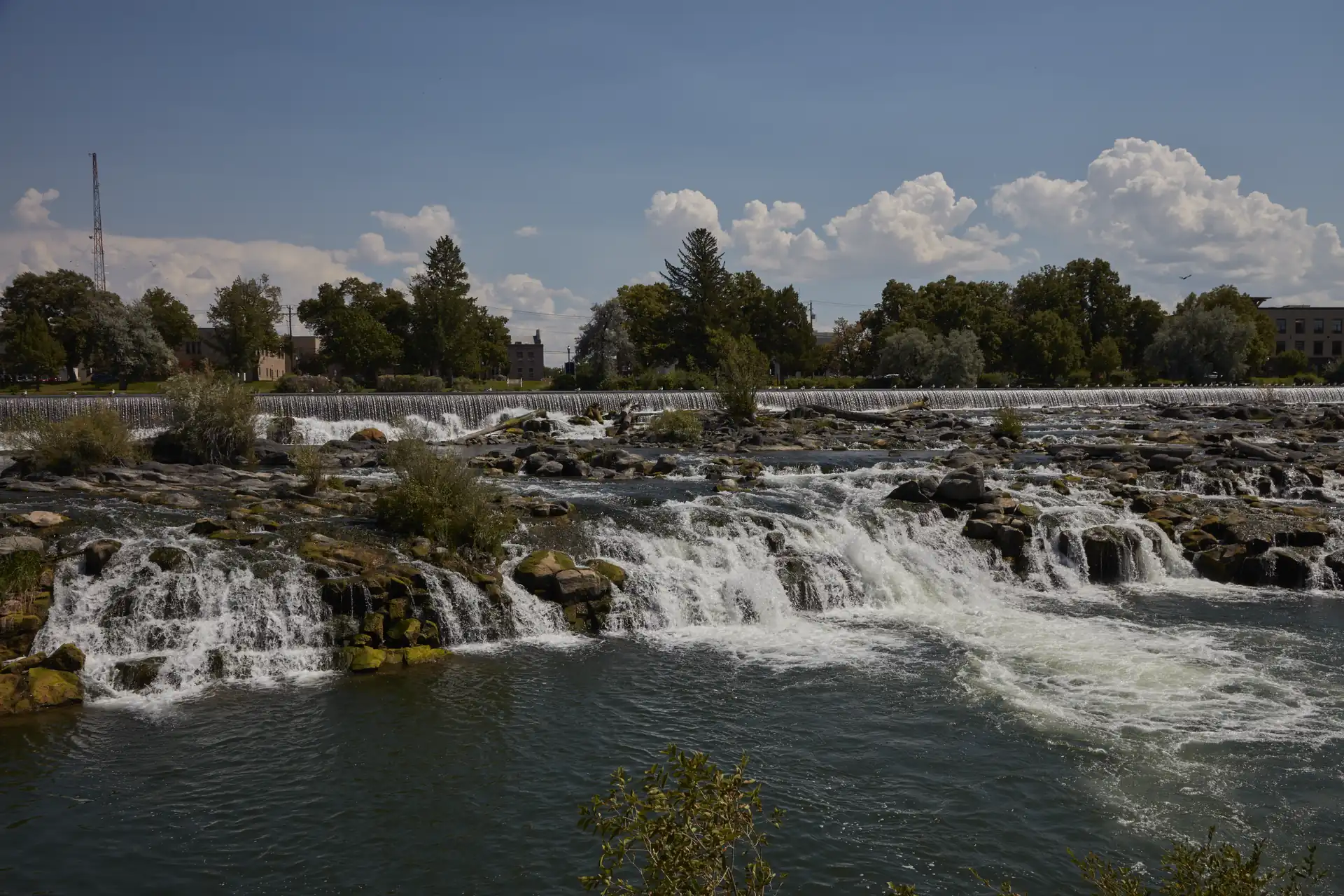 Waterfalls on the Snake River in Idaho Falls under a blue summer sky